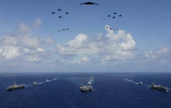 Navy ships and aircraft sailing in formation in the Pacific